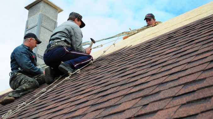 Men installing house insulation