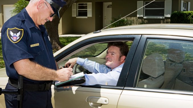 Police officer writing a traffic citation