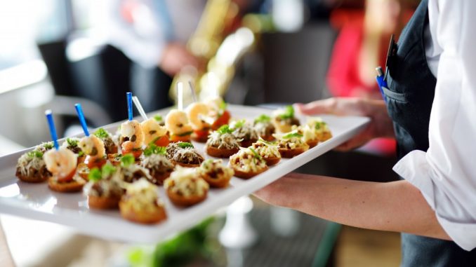 Waiter holding a tray of cupcakes