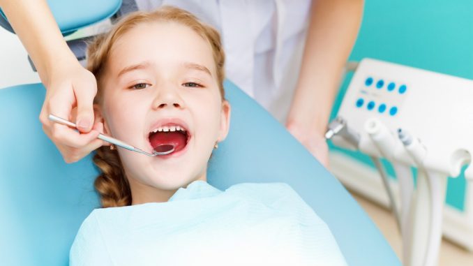 Dentist checking the teeth of a child