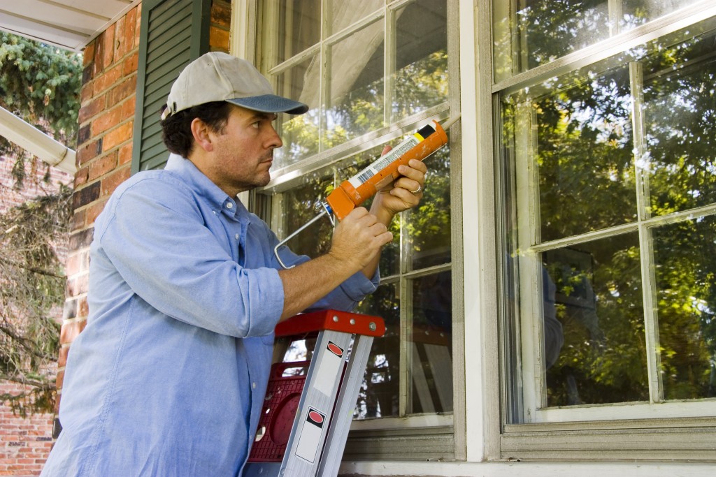 Man Air-Sealing the Home