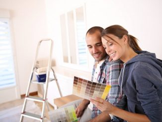 Couple choosing wall color for room renovation