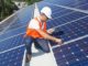 technician checking solar panels