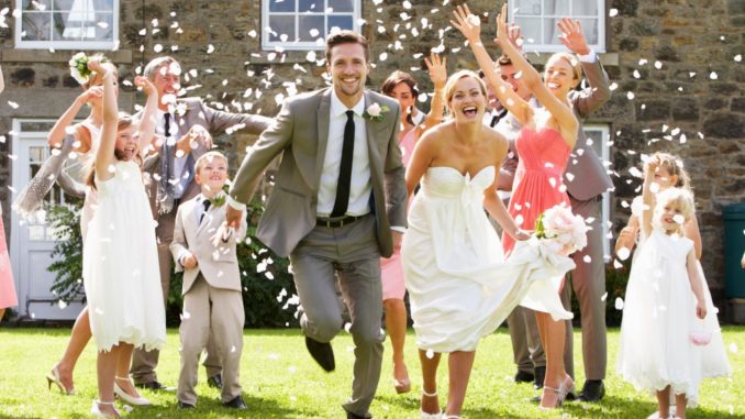 Guests Throwing Confetti Over Bride And Groom