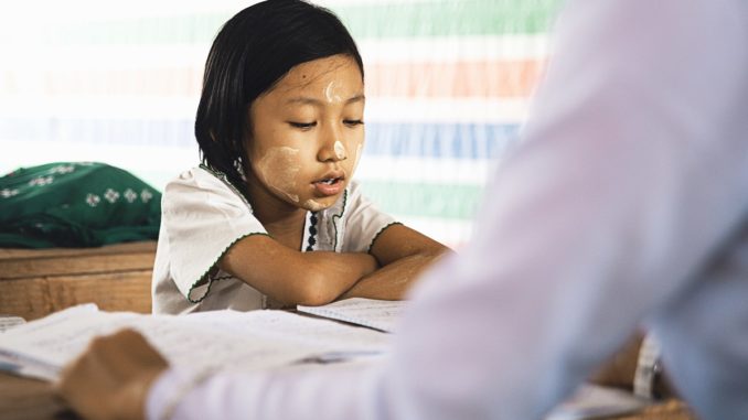 a kid reading in class