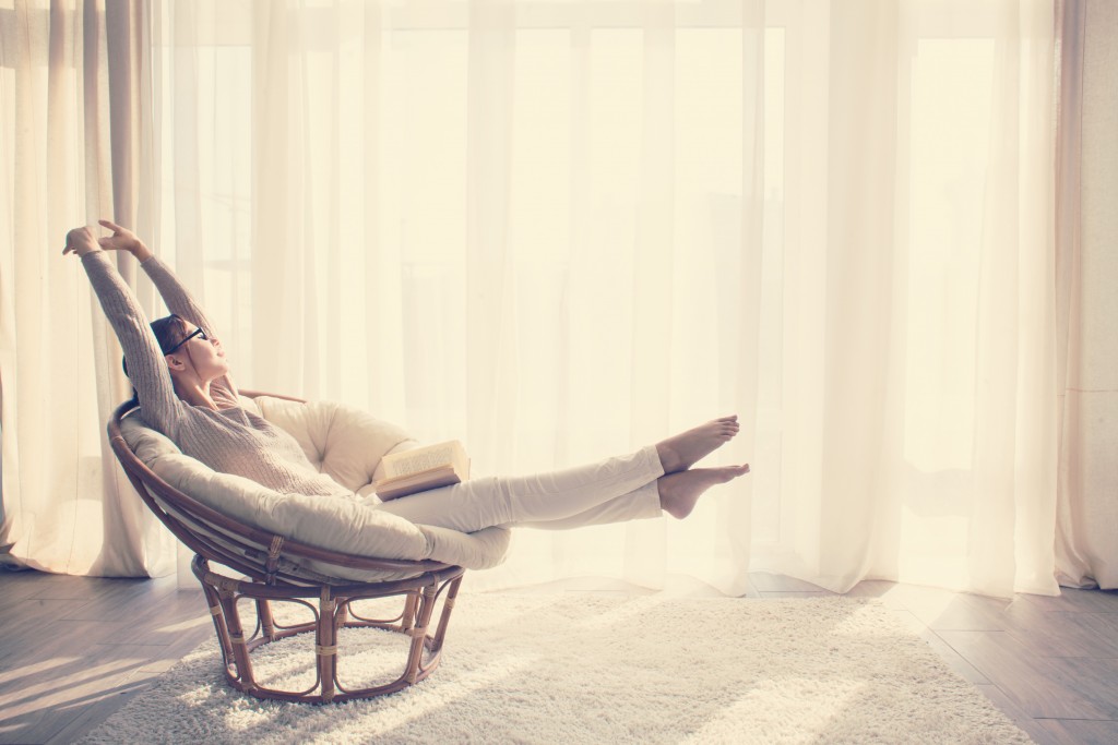 Woman reading on a modern chair