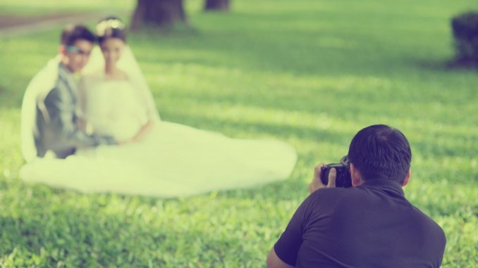 a wedding photographer taking shots of a married couple