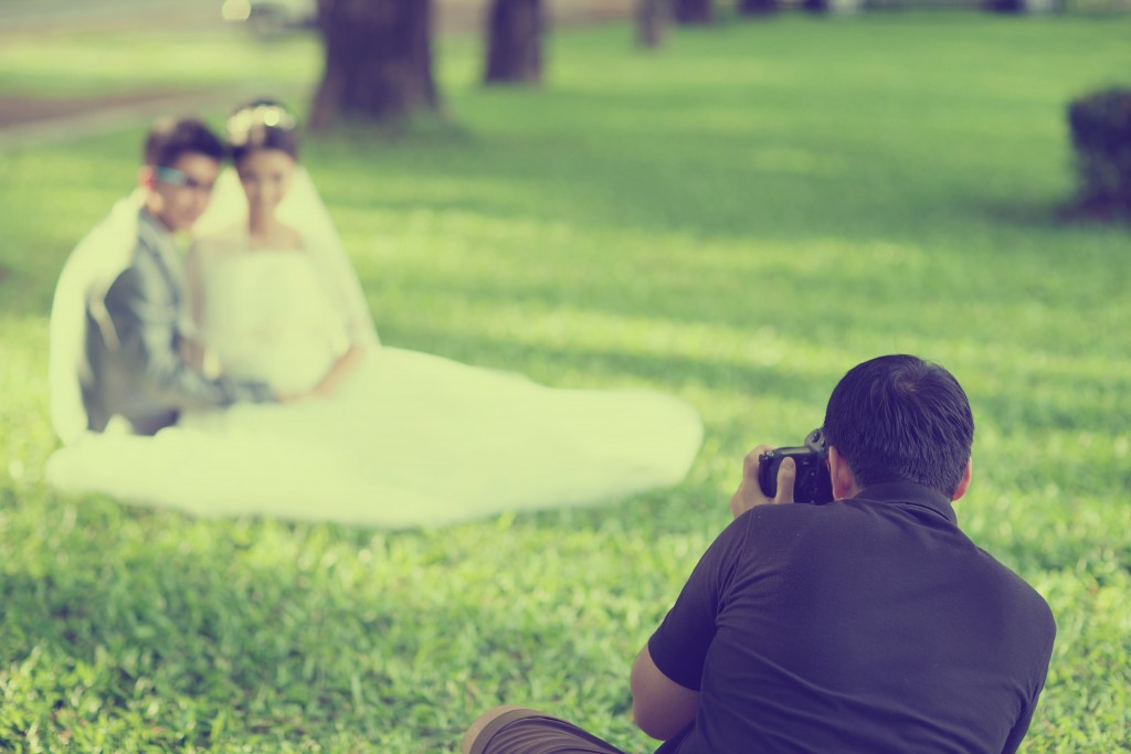 a wedding photographer taking shots of a married couple