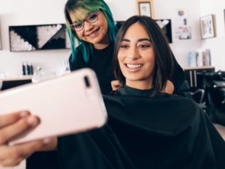 girl taking a selfie with her hairdresser