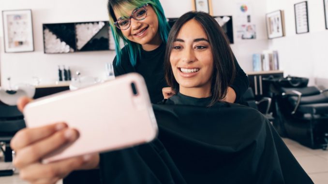 girl taking a selfie with her hairdresser