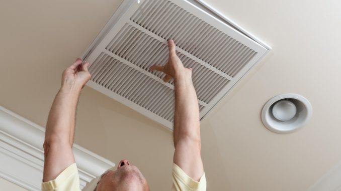 Man fixing open filter holder