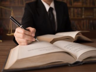 lawyer writing on the book