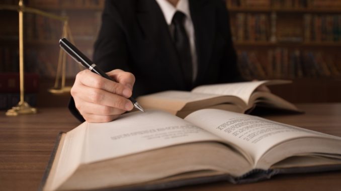 lawyer writing on the book