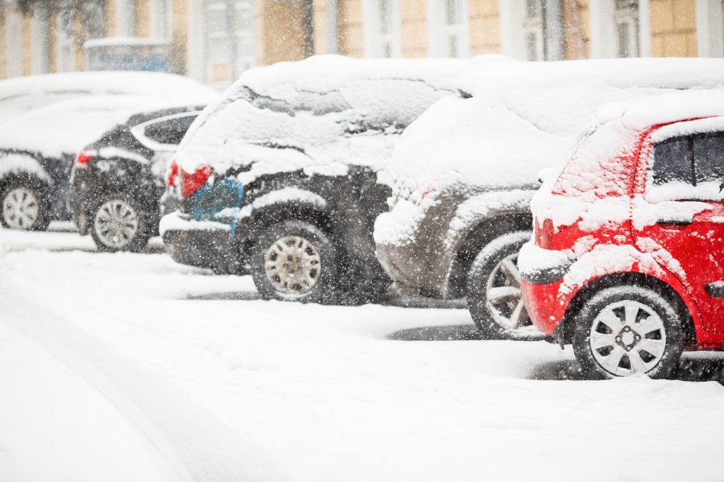 Cars covered with fresh white snow