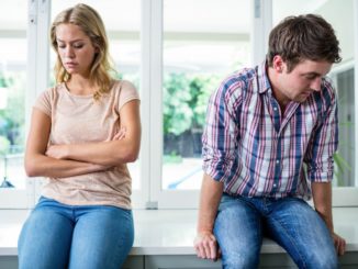 Annoyed couple ignoring each other in the kitchen