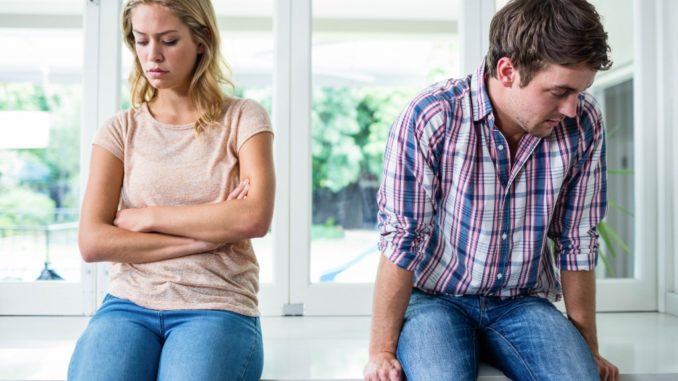 Annoyed couple ignoring each other in the kitchen