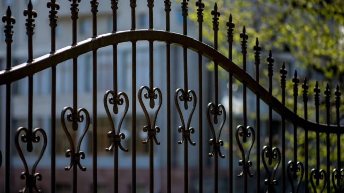 black iron fence of large building