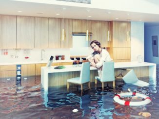 woman sitting on a chair in flooded kitchen interior