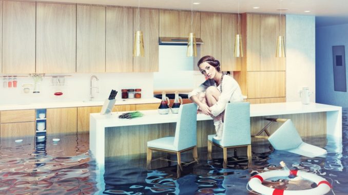 woman sitting on a chair in flooded kitchen interior