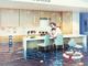 woman sitting on a chair in flooded kitchen interior