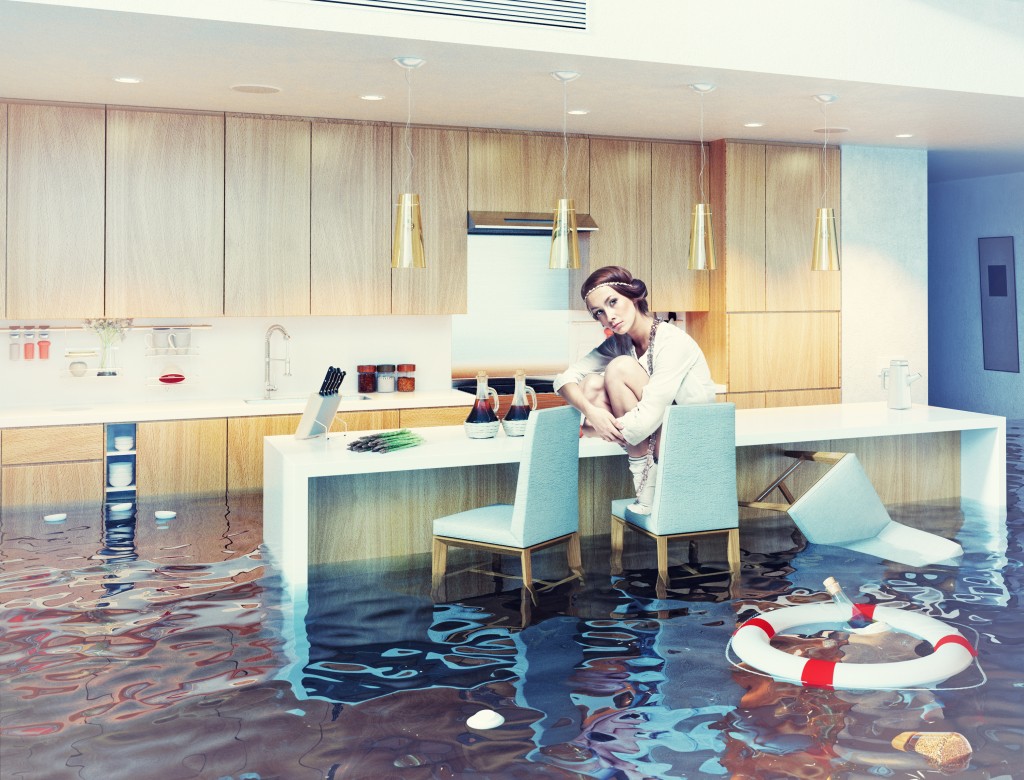 woman sitting on a chair in flooded kitchen interior