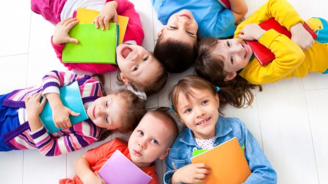 students holding a book