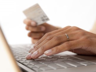 woman placing card details on the computer