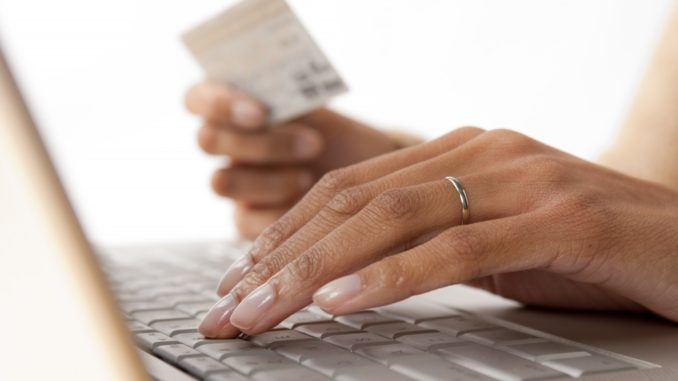 woman placing card details on the computer