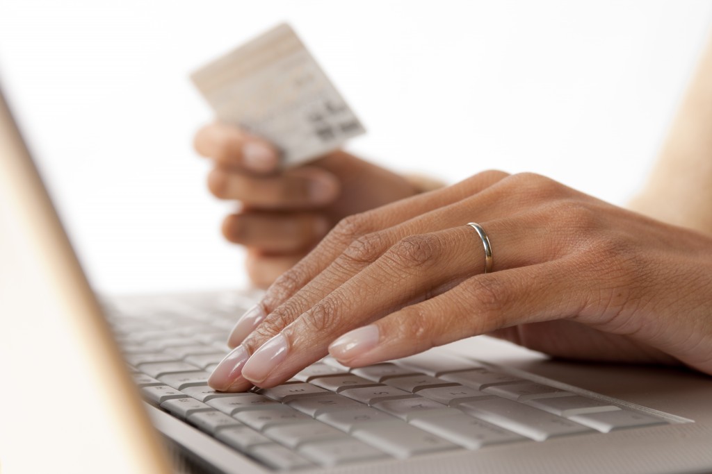 woman placing card details on the computer