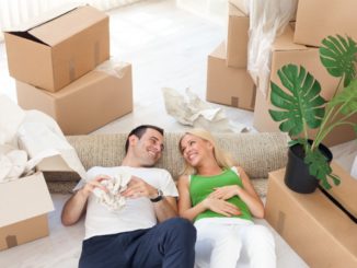 couple relaxing in the middle of cardboard boxes