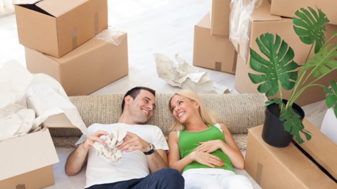 couple relaxing in the middle of cardboard boxes