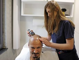 a man getting is head shaved