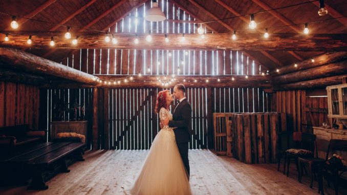 groom and bride in a barn wedding