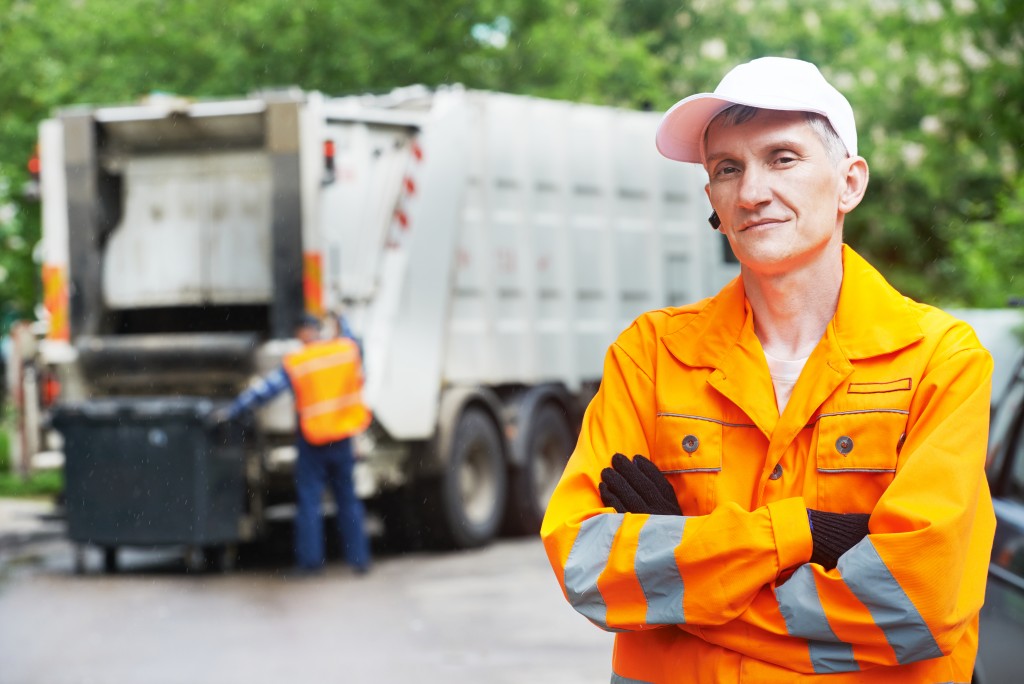 worker in yellow uniform working in waste management