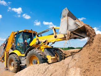 Excavator unloading sand