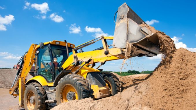 Excavator unloading sand