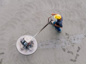 aerial view of a worker flattening a concrete