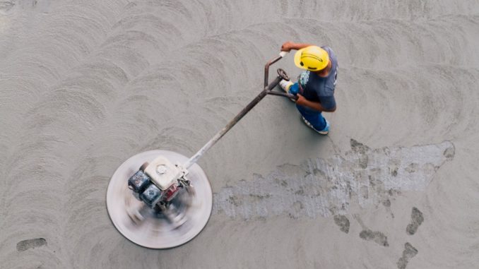 aerial view of a worker flattening a concrete