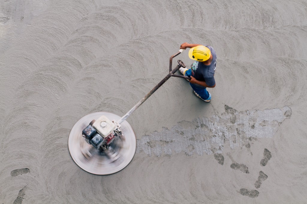 aerial view of a worker flattening a concrete