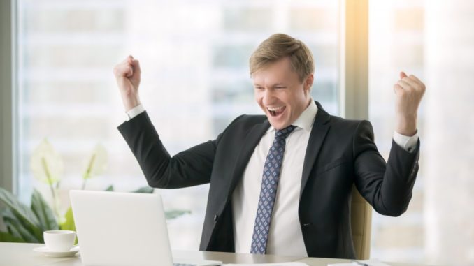 Young happy businessman with really impressive achievements