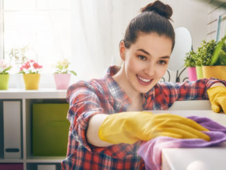 Female wiping dust off counter