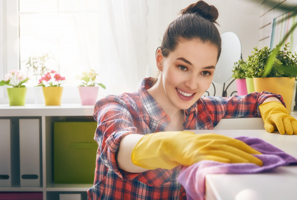 Female wiping dust off counter