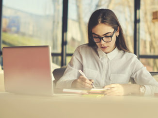 woman taking notes