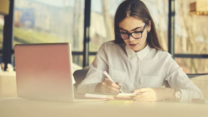 woman taking notes