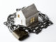 a paper house, chain, and a padlock